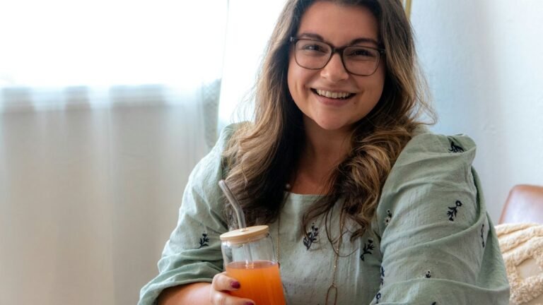 a woman holding a glass of beer